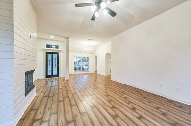 View from the back of the house looking through the Family Room showing the entryway and dining room. Decorative column helps define the entryway. Notice the other thoughtful details like the transom over the front door and the arches leading from the dining room to the kitchen and breakfast room.