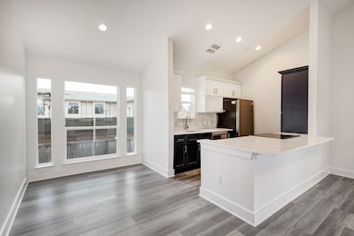 Bright and airy dining area flows into the modern, updated kitchen.