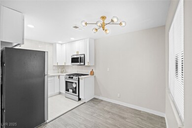 Kitchen featuring stainless steel appliances, back