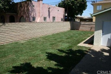 Big elongated yard with brick fence. New lawn and 