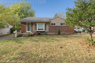 View of front of house featuring brick siding, a front lawn, and roof with shingles