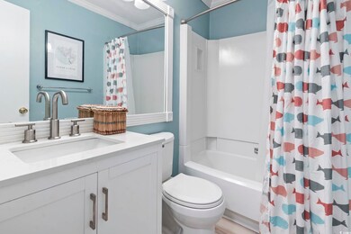 Full bath featuring vanity, ornamental molding, toilet, and shower / tub combo with curtain
