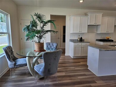 Dining area with dark wood finished floors and recessed lighting
