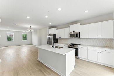 The kitchen offers loads of cabinets and counter space.
