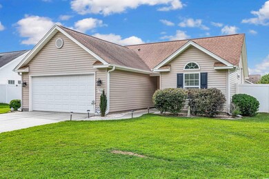 Single story home featuring a garage and a front y