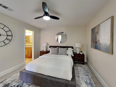 Bedroom featuring baseboards, visible vents, and l