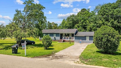 Ranch-style home with a porch, crawl space, concrete driveway, a front yard, and a shingled roof
