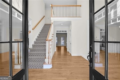 Double French Doors lead to two-story Foyer