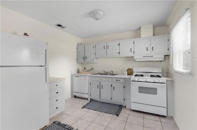 Kitchen featuring light countertops, visible vents