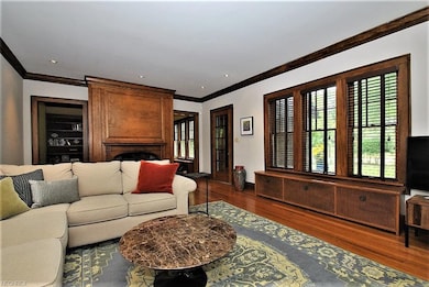 Large living room with natural woodwork, wood floo