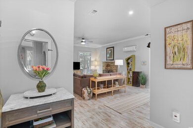 Dining room featuring a wall mounted AC, light har