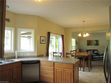 Glass doors lead to rear deck, patio, pool and bac