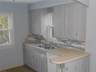 This kitchen has two windows & an updated tile bac