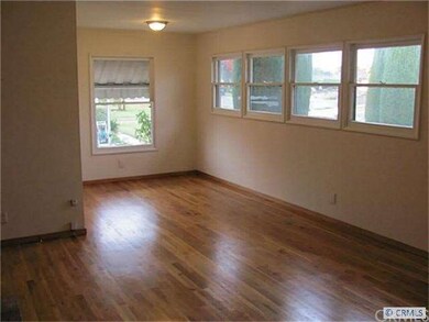 Living room with refinished floors& lots of window