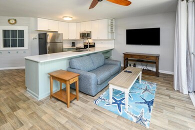Living area featuring light wood-style floors, ceiling fan, and baseboards