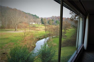 STANDING AT THE PICTURE WINDOW AND ENJOYING THE PE
