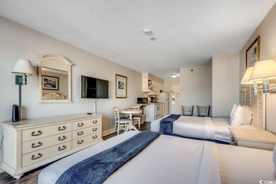 Bedroom with dark wood-type flooring, baseboards, 