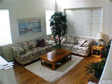 Living room with wood flooring and volume ceilings