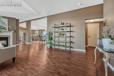 Family room with a tiled fireplace, baseboards, lo