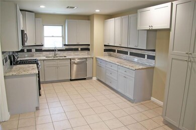Newly renovated kitchen with granite counters and new dishwasher, stove and microwave.