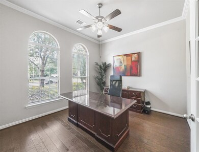 Private study with double glass doors.  Large arched windows provide plenty of natural lighting.  The perfect place to home office.