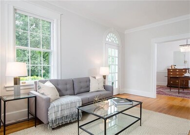 The living room has hardwood flooring, crown moldi
