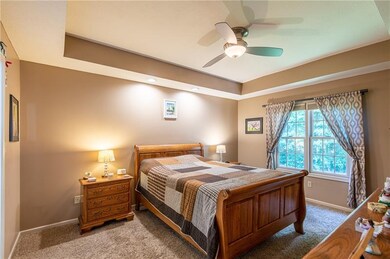 The master bedroom offers plenty of light, a walk in closet and a tray ceiling.