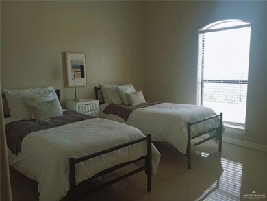 Bedroom with light tile patterned floors and baseboards