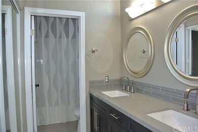 Remodeled master bath with dual sinks, rich, dark 