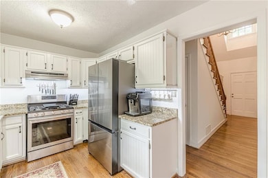 Kitchen with stainless steel appliances, under cab