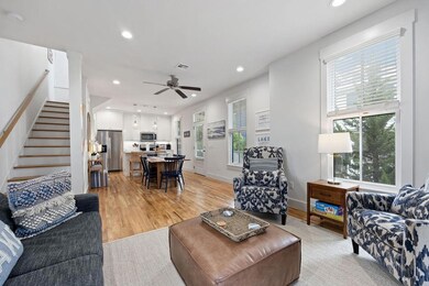 Living room featuring stairs, recessed lighting, l