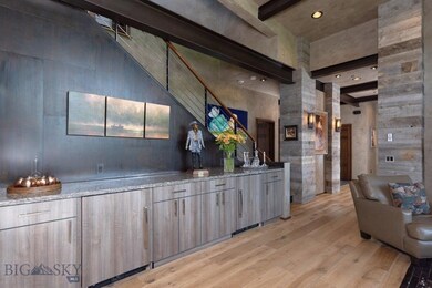Main level living area bar and steel staircase to