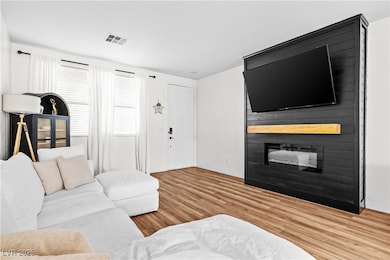 Living area featuring a large fireplace, visible v