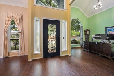 Entrance foyer featuring a high vaulted ceiling, d