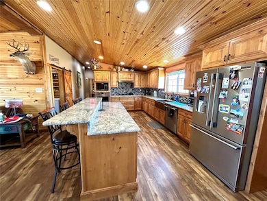 Kitchen with granite countertops and island.