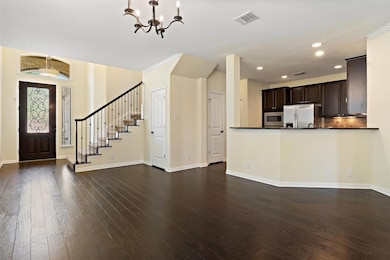 Entrance foyer with a chandelier, dark wood-style flooring, recessed lighting, and stairway