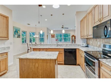 Open kitchen overlooks living room and beautiful b