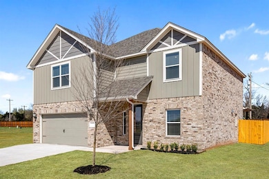 This storybook home greets you with a charming front porch and lush greenery, perfect for relaxing evenings.