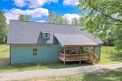Rear view of house featuring a wooden deck and a s