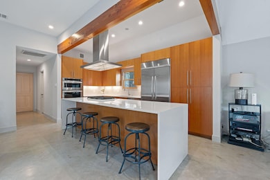 Kitchen featuring brown cabinetry, modern cabinet