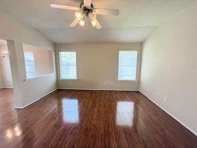 Unfurnished room featuring vaulted ceiling, wood f