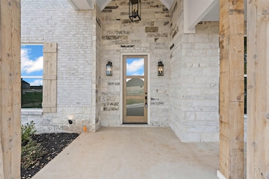 Entrance to property with stone siding