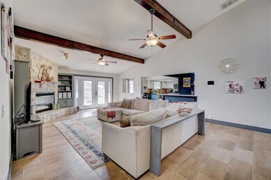 Living room with a fireplace, lofted ceiling with 
