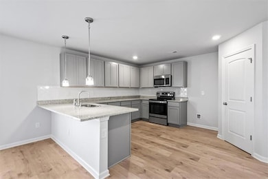 Kitchen featuring stainless steel appliances, ligh