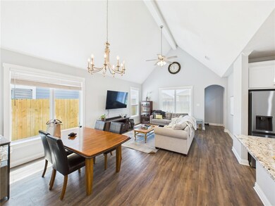 Dining room featuring arched walkways, beamed ceil