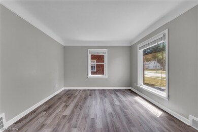 Empty room featuring plenty of natural light and hardwood / wood-style floors