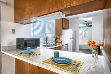 Breakfast bar and kitchen. Window looks out to pool.