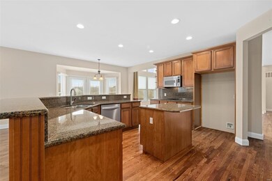 Big, open kitchen with center island, breakfast bar and stainless appliances