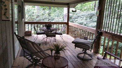 Covered back deck: Private and wooded back deck ac