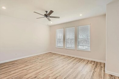Unfurnished room featuring ceiling fan, light woo